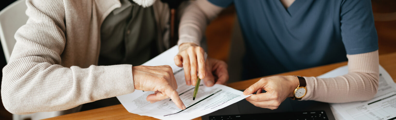 A man and his caregiver review Annuities Peoria IL paperwork