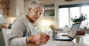 A woman reviews her financial statements to begin exploring annuities in Morton IL for retirement income planning