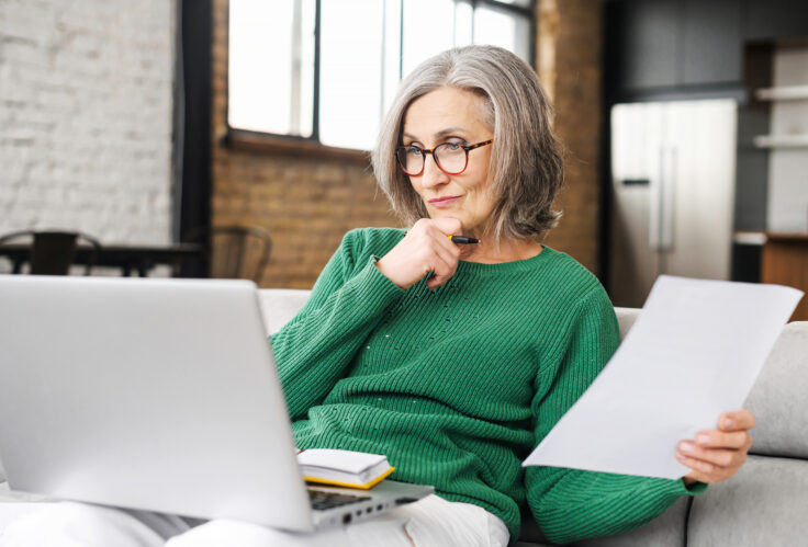 A woman reviews her finances as she starts Building a Long Term Insurance Strategy