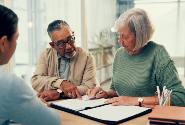 A couple fills out paperwork for their life insurance